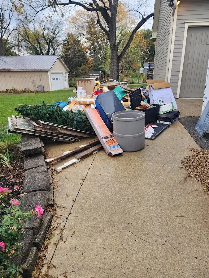 Dumpster being loaded with debris for Estate Cleanout Dumpster Rental in Madawaska
